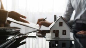 Homeowner reviewing insurance documents and comparing coverage details at a kitchen table